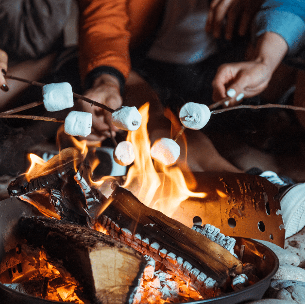 Family enjoying a cozy beach bonfire at sunset